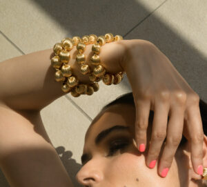 Aesira" 24k gold-plated bracelet with intricately woven textured beads, designed for elegance and sophistication.