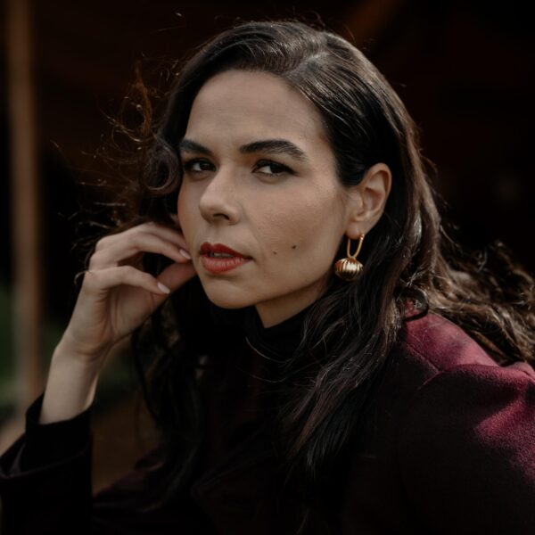 Close-up of 24k gold-plated ribbed earrings with intricate detailing